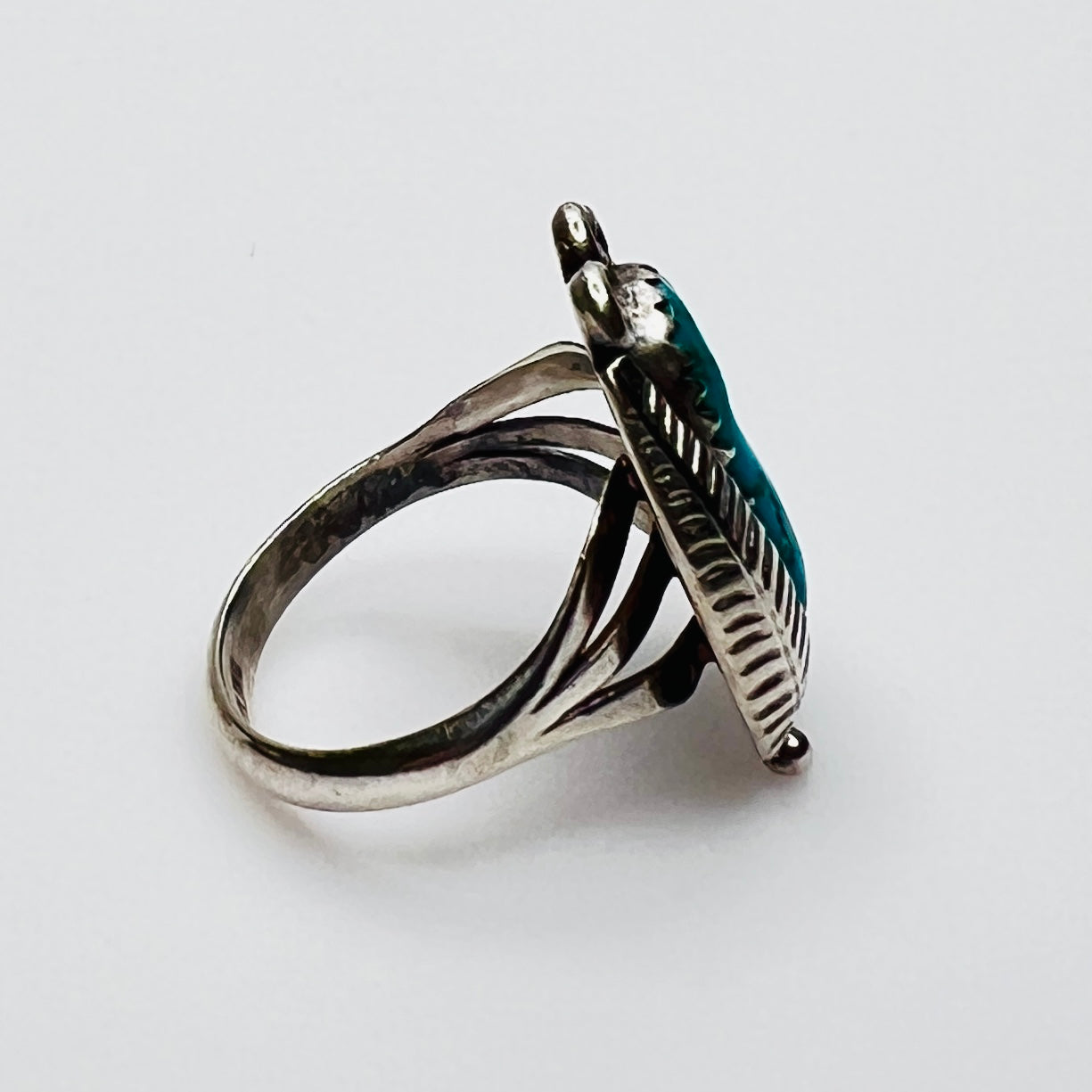 side view of turquoise cabochon feather statement ring