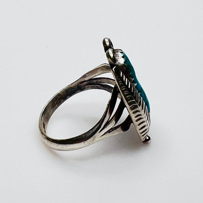 side view of turquoise cabochon feather statement ring