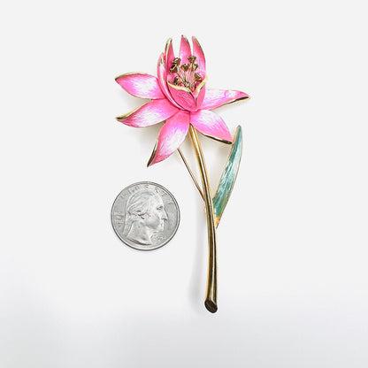 Park Lane pink floral brooch shown beside quarter for scale with green enamel leaf