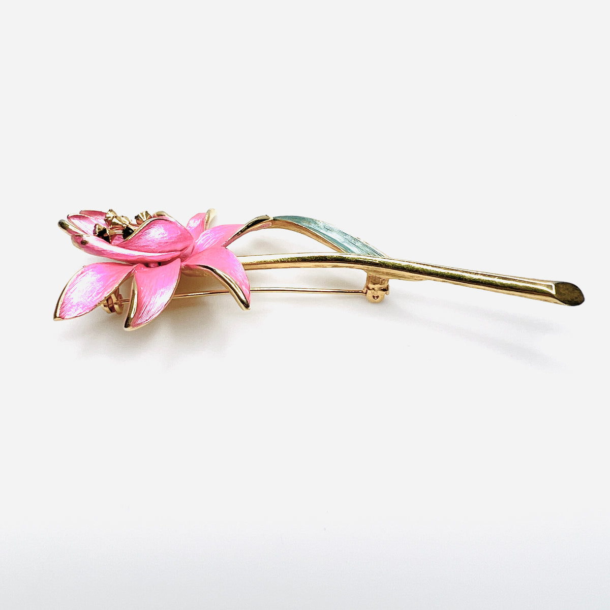 Side view of dimensional pink enamel flower brooch with layered petals and long gold stem