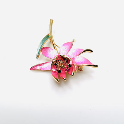 Side view of dimensional pink enamel flower brooch with layered petals and long gold stem
