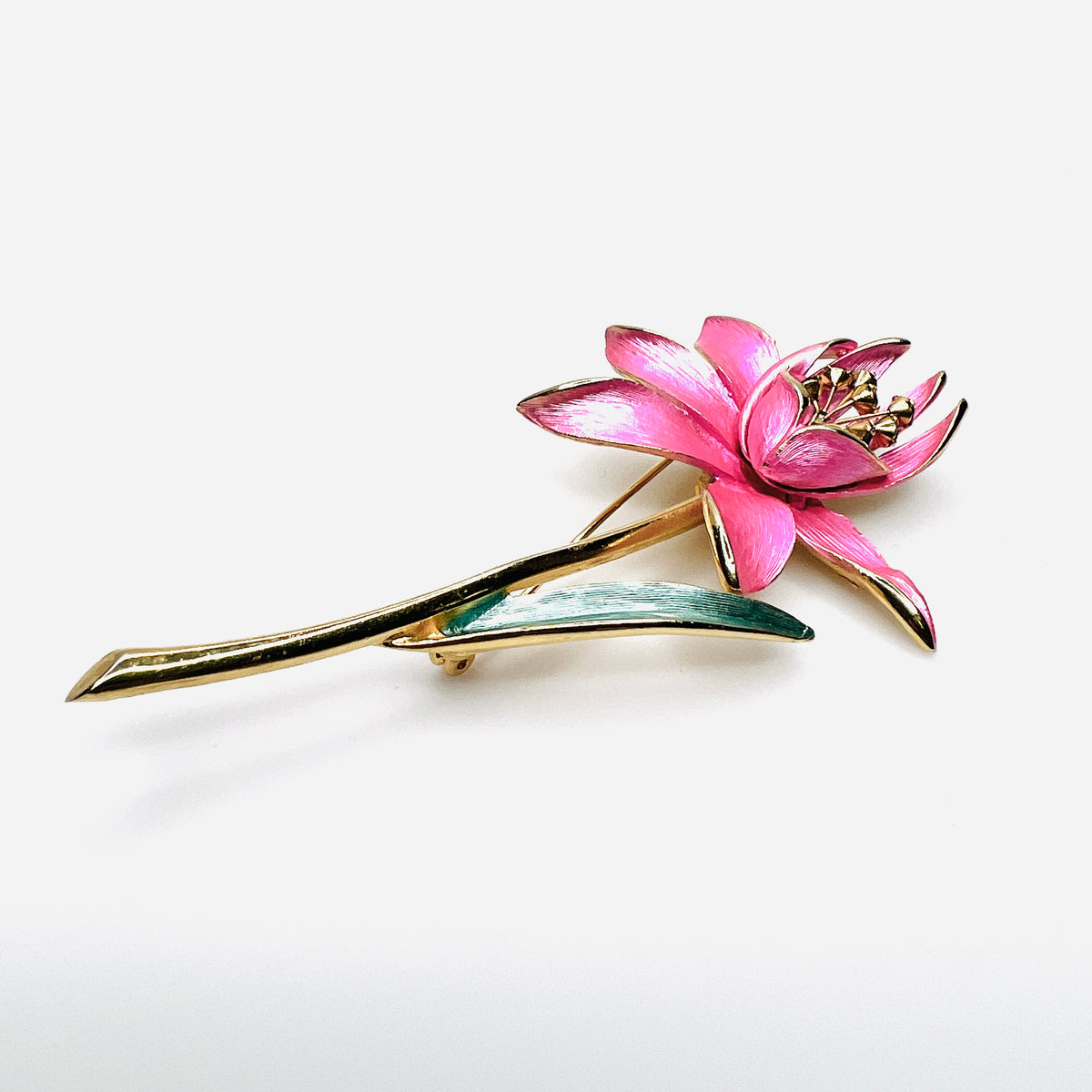 Side view of dimensional pink enamel flower brooch with layered petals and long gold stem