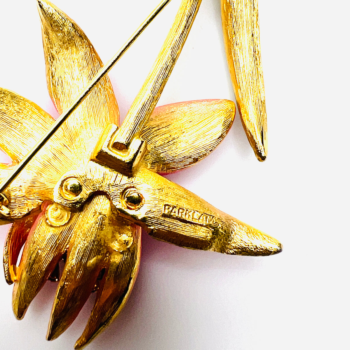 Close-up of PARK LANE signature on reverse of vintage pink enamel floral brooch