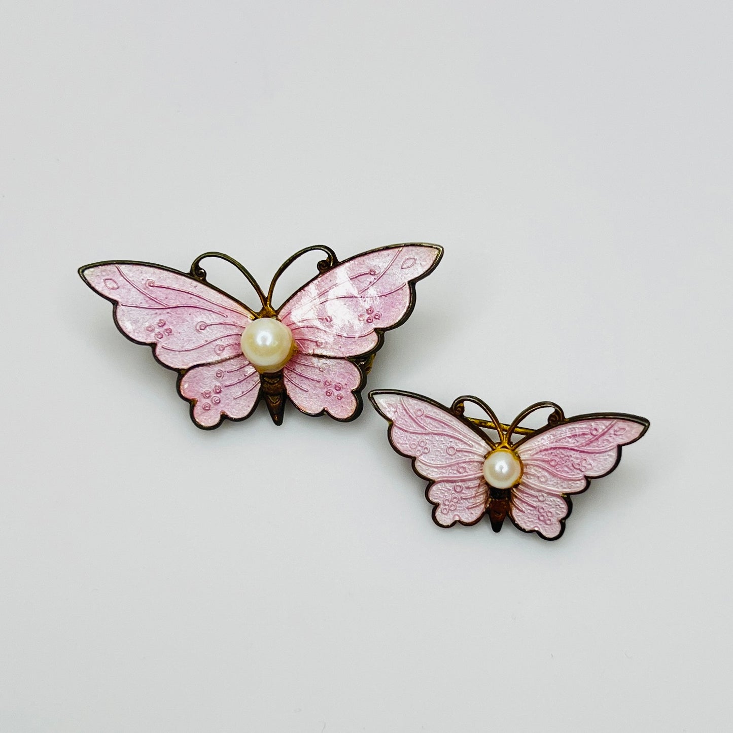 Pair of vintage pink enamel butterfly brooches with genuine pearl centers