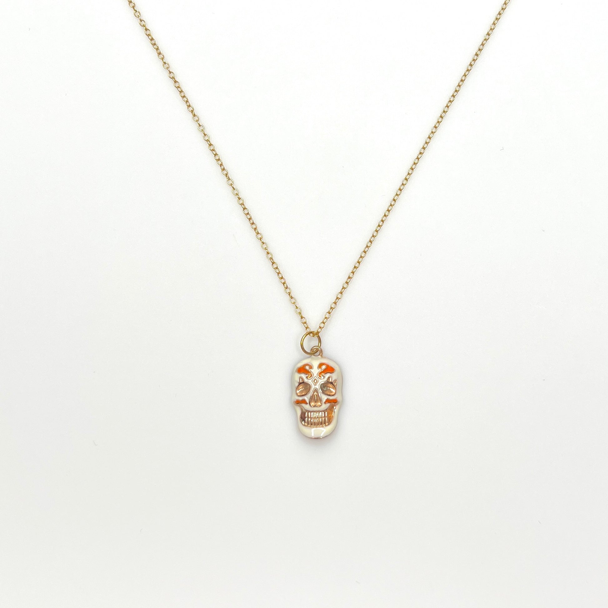 Vintage enamel sugar skull pendant necklace with white and rose gold details on gold-filled chain.