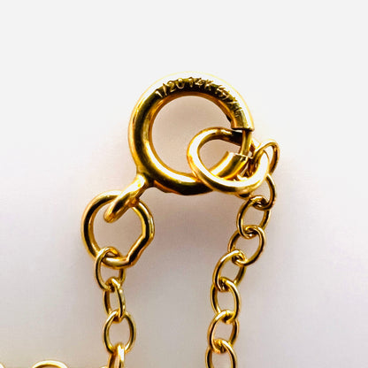 Close-up of spring ring clasp stamped 1/20 14K on vintage necklace.