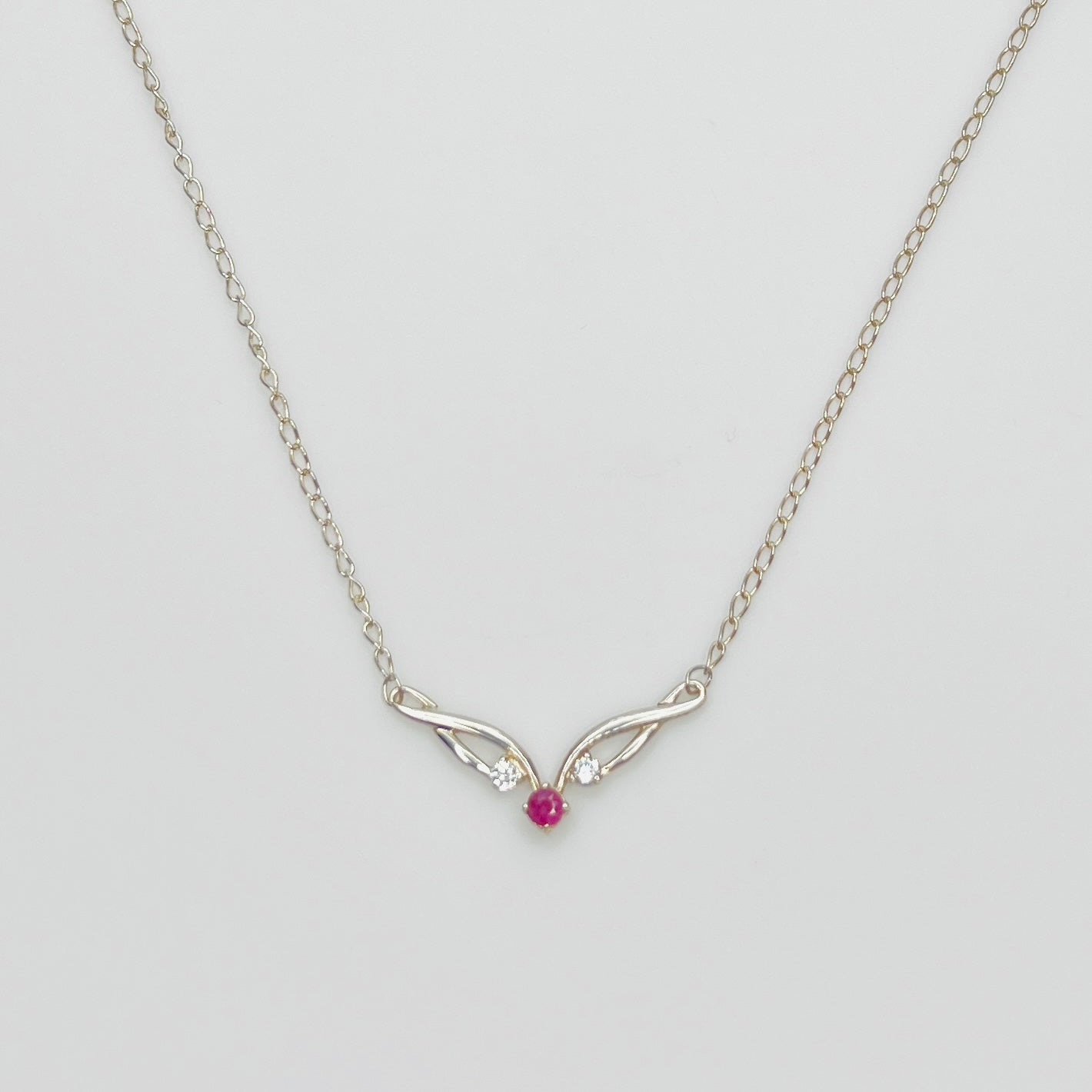 Sterling silver necklace with ruby center stone and CZ accents