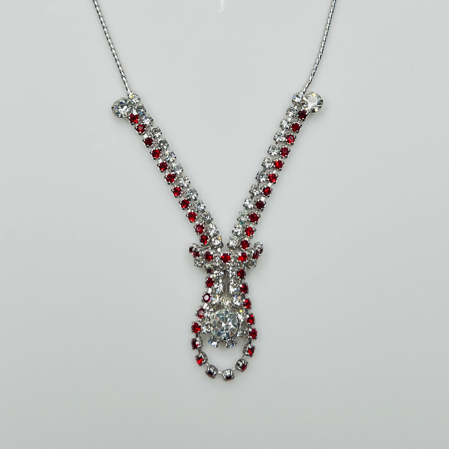 Close-up of 1950s V-shaped red rhinestone drop necklace