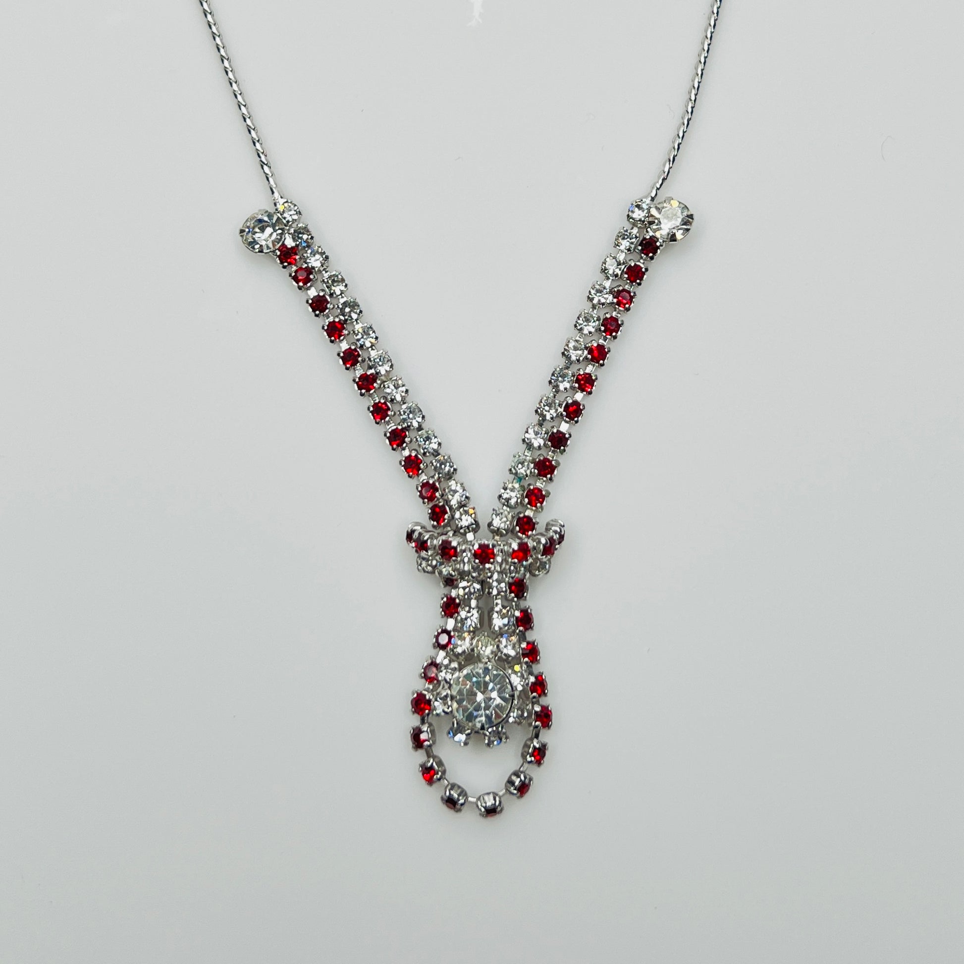 Close-up of 1950s V-shaped red rhinestone drop necklace