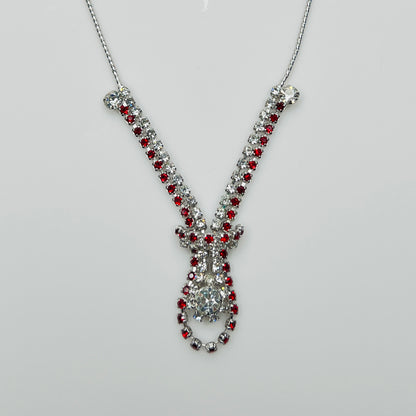 Close-up of 1950s V-shaped red rhinestone drop necklace