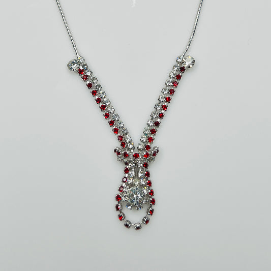Close-up of 1950s V-shaped red rhinestone drop necklace