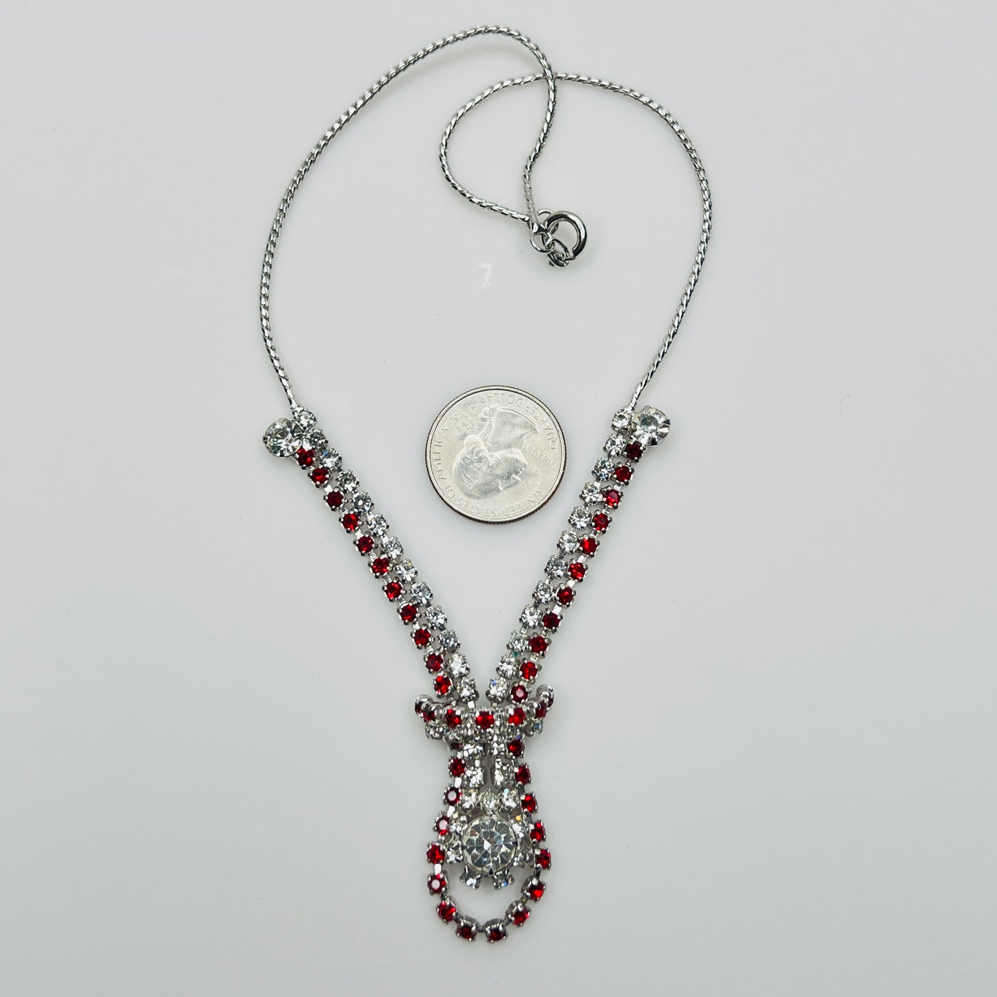 Vintage red and clear rhinestone necklace with quarter for scale, spring ring clasp