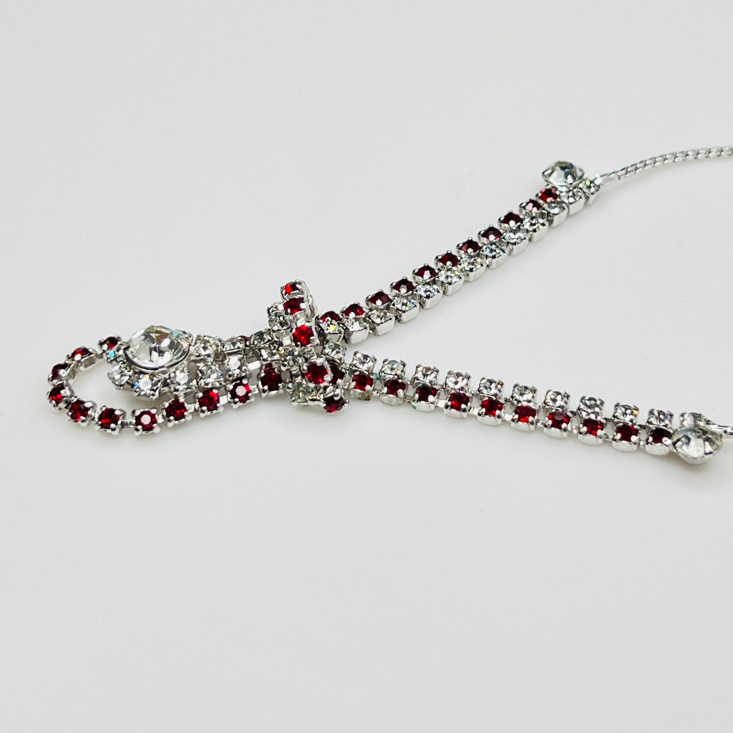 Close-up of 1950s V-shaped red rhinestone drop necklace