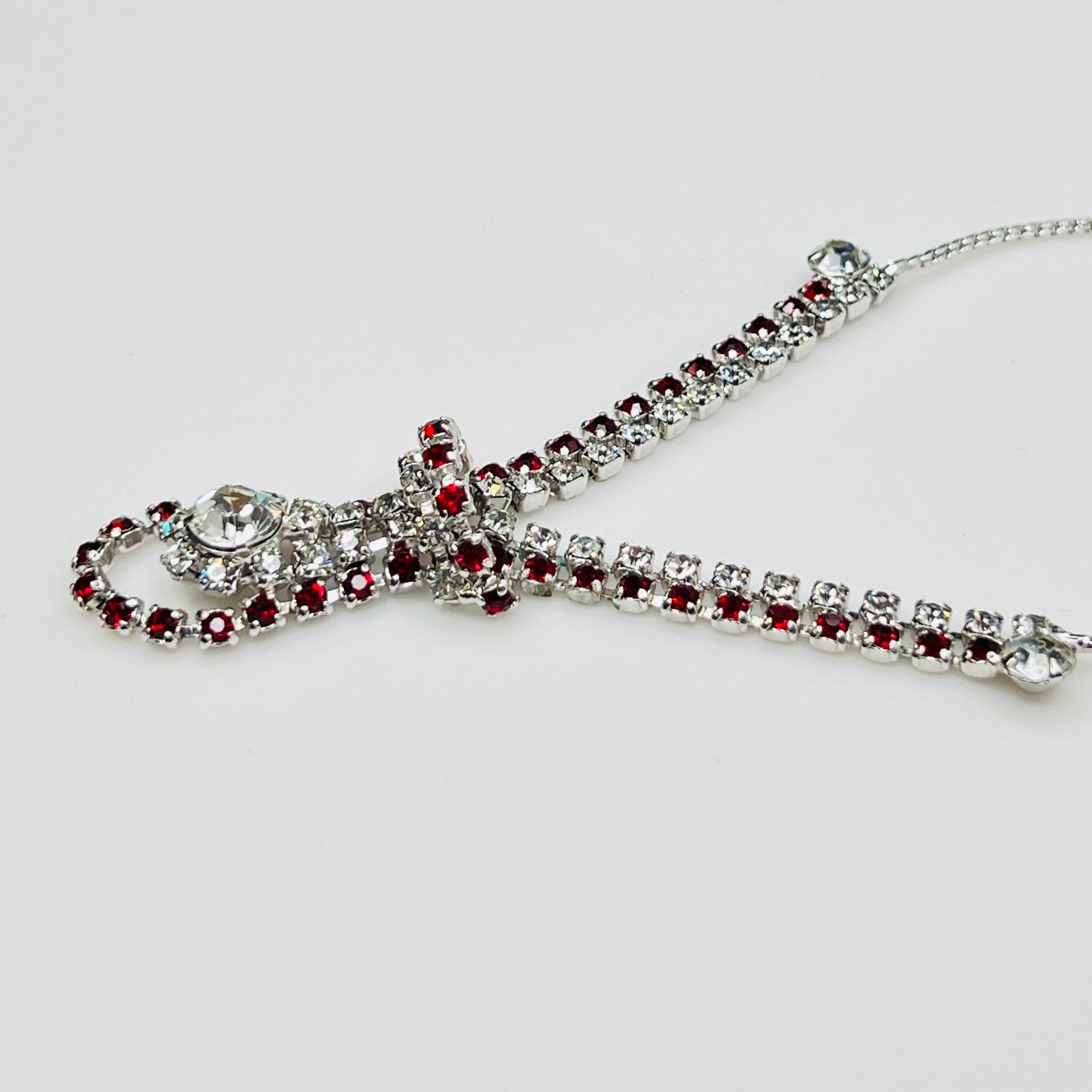 Close-up of 1950s V-shaped red rhinestone drop necklace