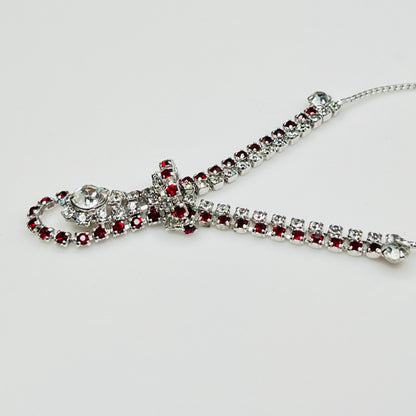 Close-up of 1950s V-shaped red rhinestone drop necklace