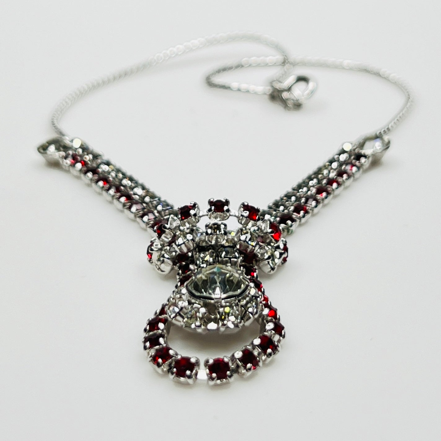 Close-up of 1950s V-shaped red rhinestone drop necklace