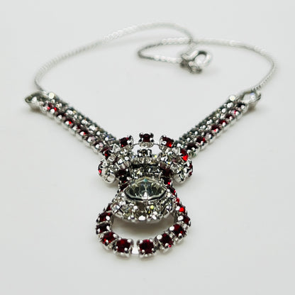 Close-up of 1950s V-shaped red rhinestone drop necklace