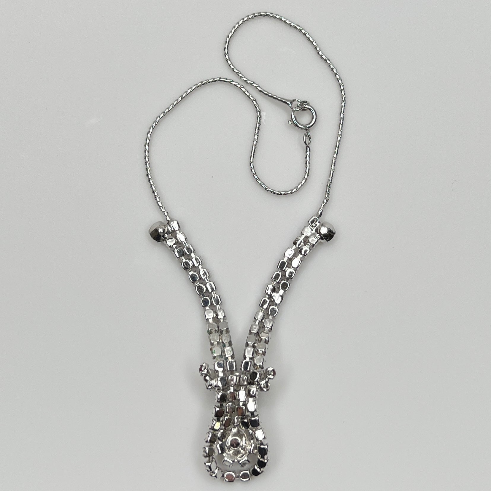 back of 1950s V-shaped red rhinestone drop necklace with spring ring clasp