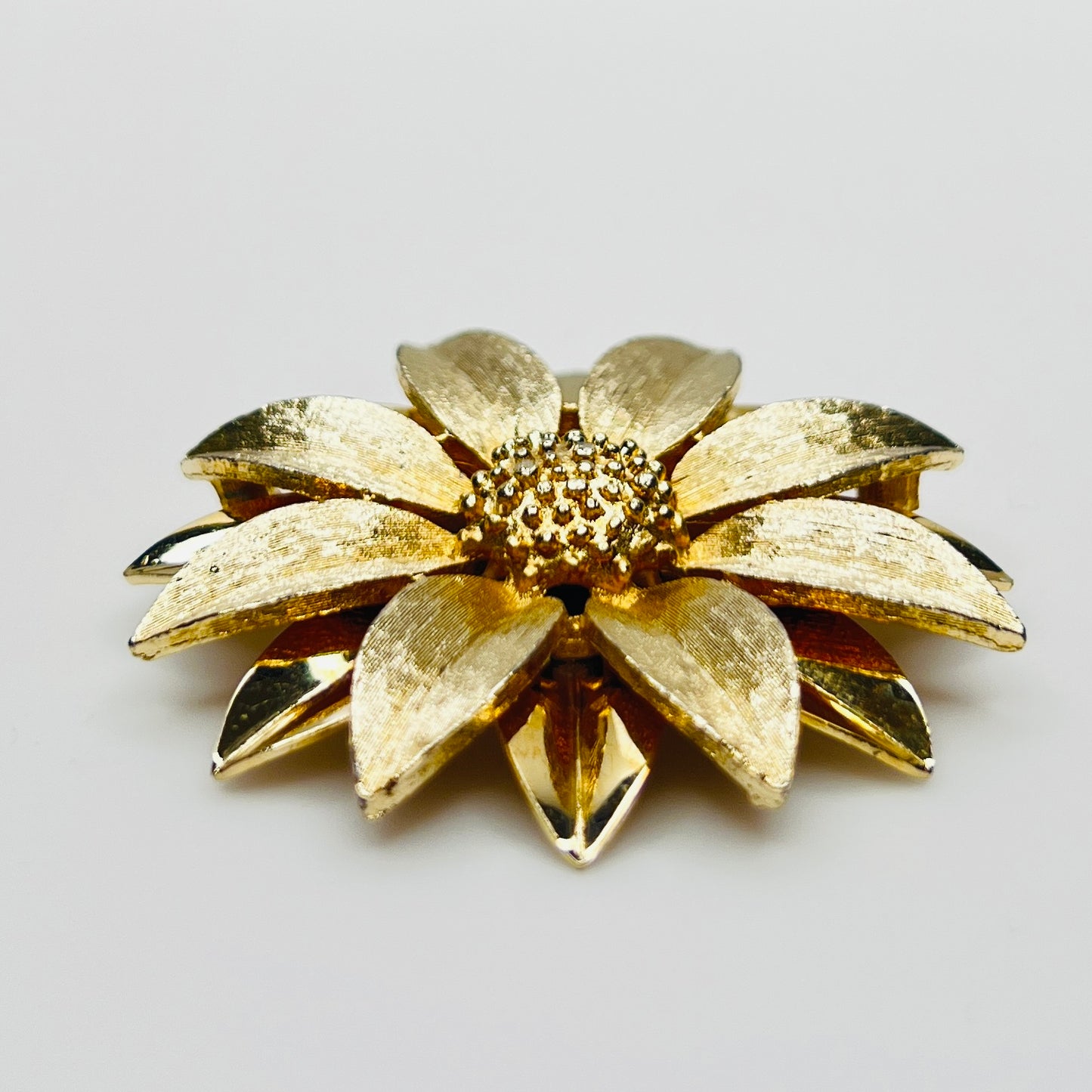 Side profile of layered daisy brooch