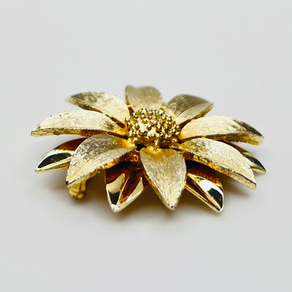 Side profile of layered daisy brooch