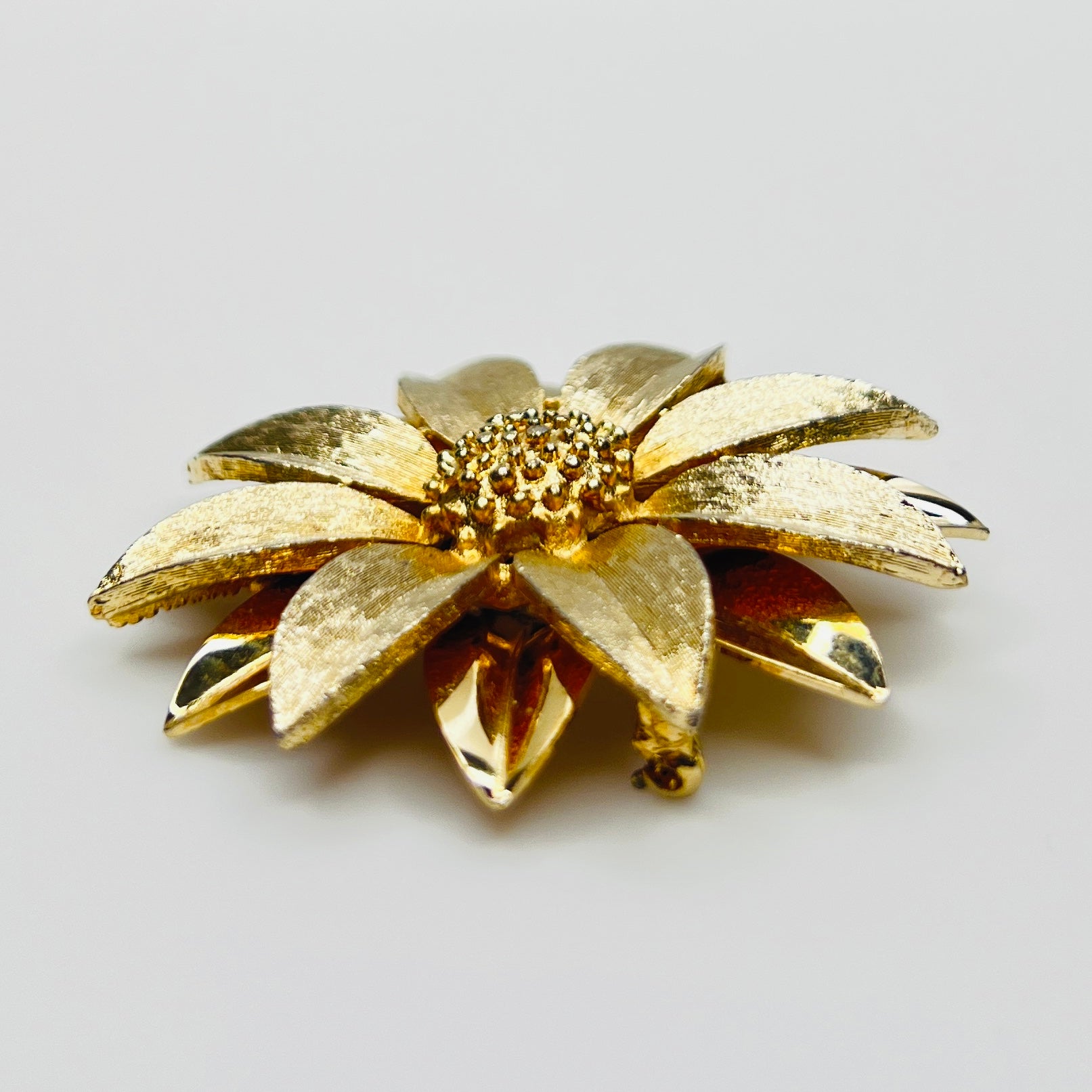 Side profile of layered daisy brooch