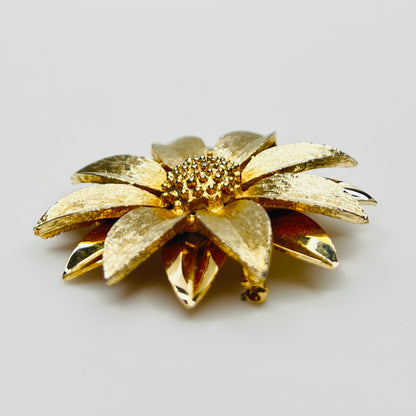 Side profile of layered daisy brooch