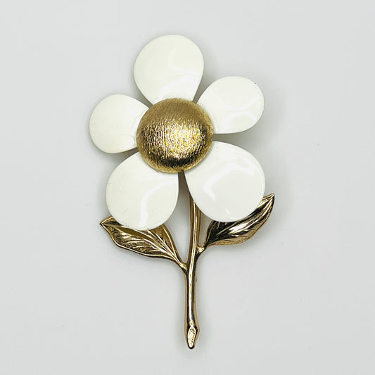 Vintage Sarah Coventry daisy brooch with five white enamel petals, textured gold-tone center, and gold leaves