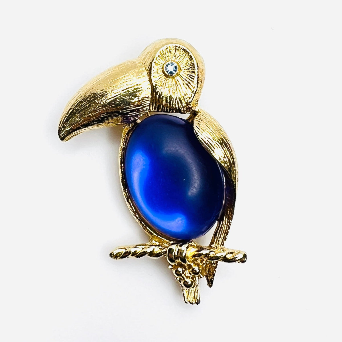 Vintage Sarah Coventry gold-tone toucan brooch with purple jelly belly and blue rhinestone eye