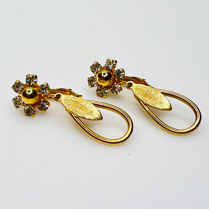 Gold tone rhinestone dangle clip on earrings with open teardrop design