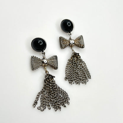 Vintage 1970s silver tone mesh bow earrings with chain tassel dangles and black acrylic studs