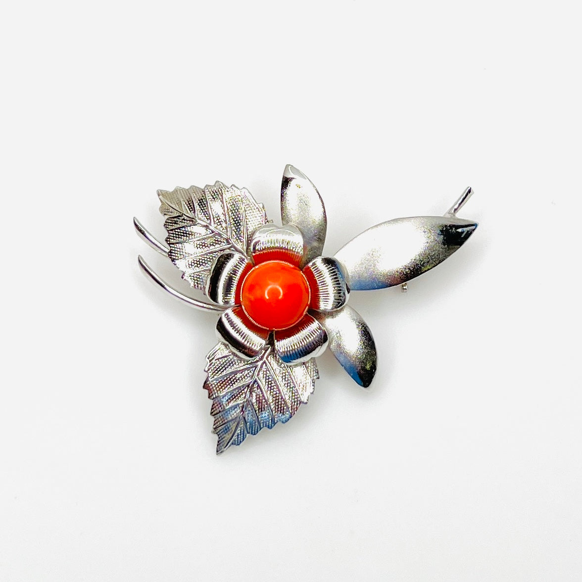 Vintage 1970s stainless steel flower brooch with bright orange center bead