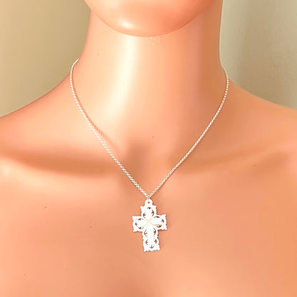 Vintage Mother of Pearl Bethlehem cross necklace worn on mannequin with sterling silver chain.