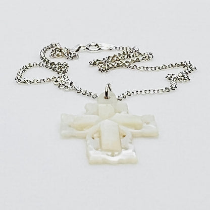 Side profile of vintage Mother of Pearl cross pendant on sterling silver chain.