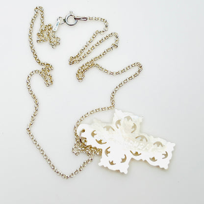Reverse of Bethlehem Mother of Pearl cross pendant showing carved back and sterling chain.