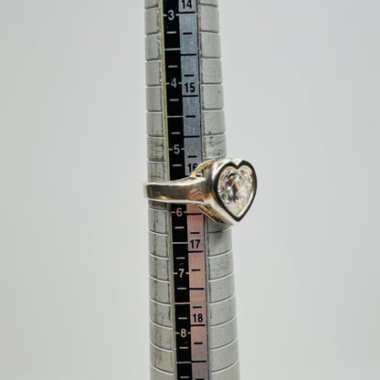 Close-up of heart-shaped CZ stone in silver setting on ring sizer