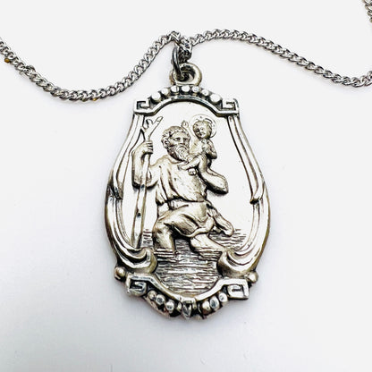 Close-up of vintage sterling silver St. Christopher religious medal pendant.