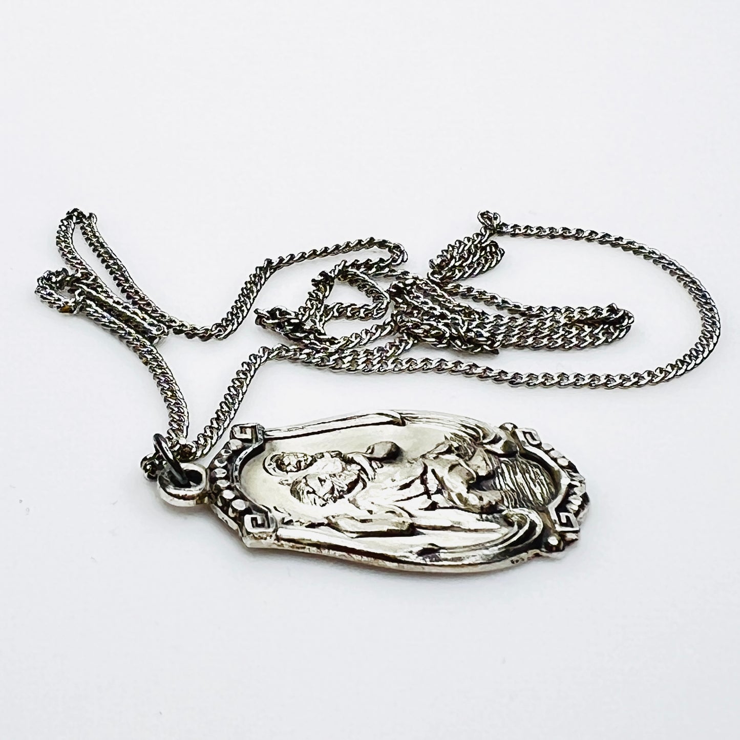 Side profile of Hayward sterling St. Christopher pendant necklace.