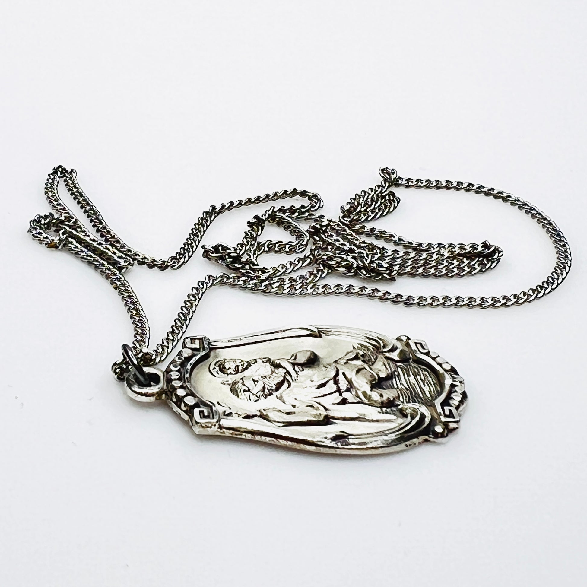 Side profile of Hayward sterling St. Christopher pendant necklace.