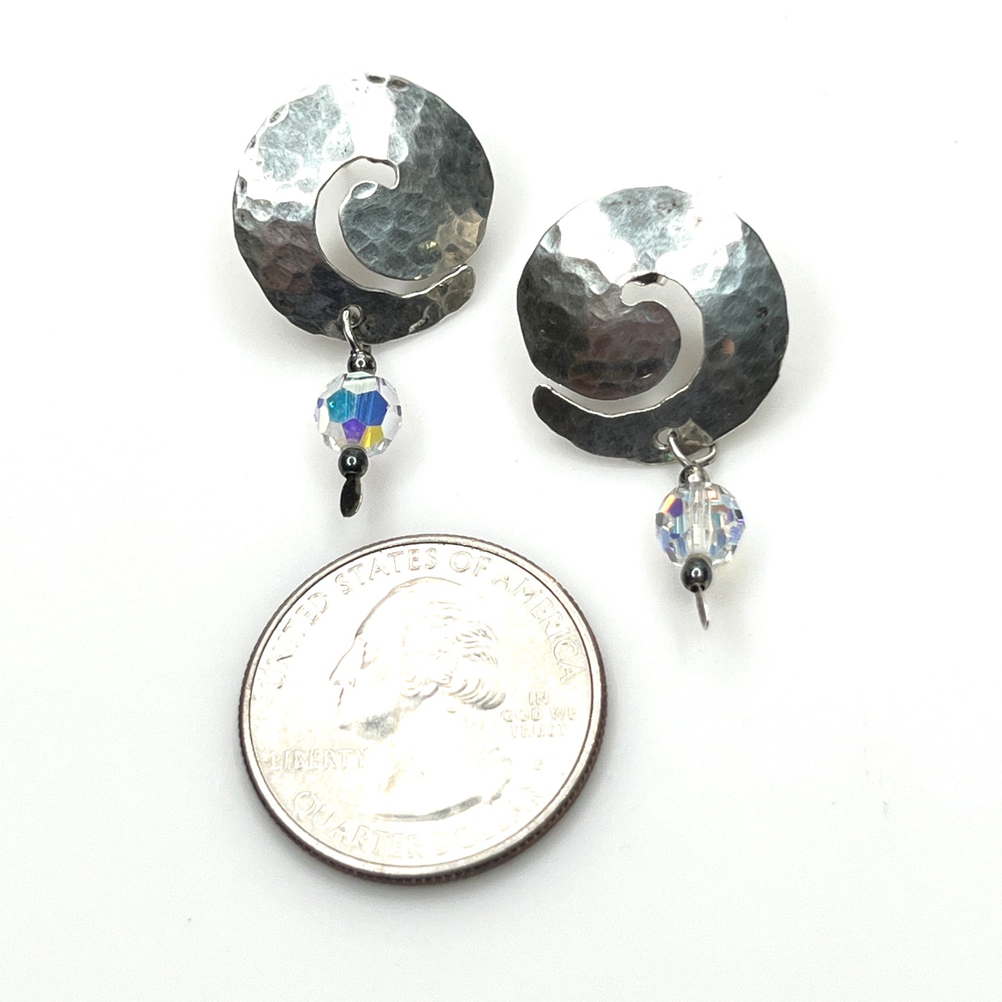 Hammered sterling silver spiral earrings with aurora borealis crystal accents with quarter for scale