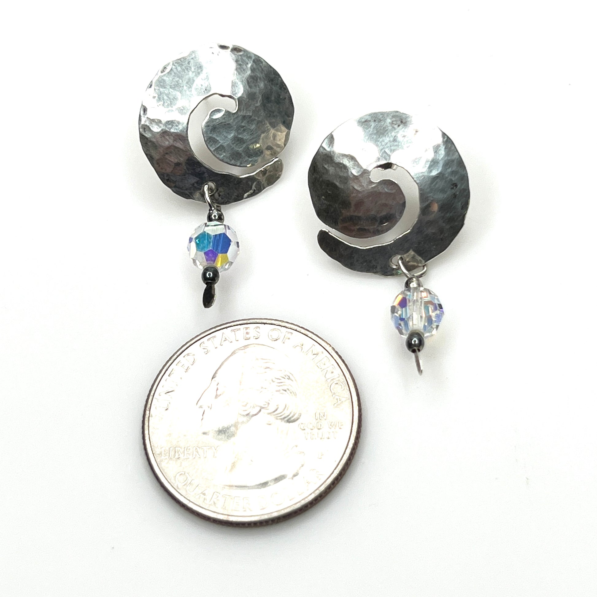 Hammered sterling silver spiral earrings with aurora borealis crystal accents with quarter for scale