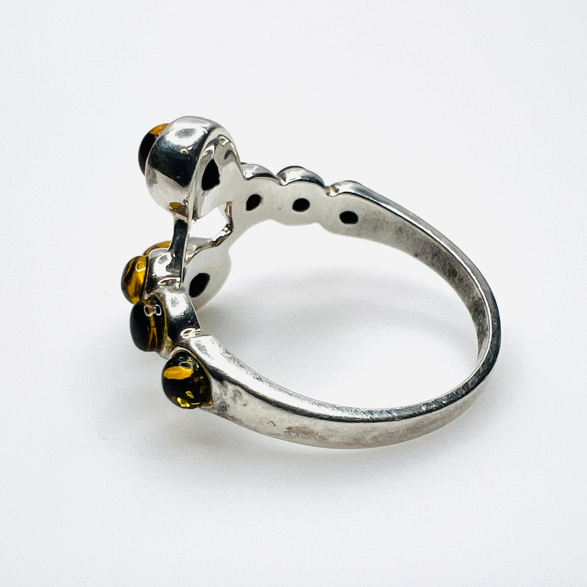 Side view of vintage S925 silver ring with cognac Baltic amber cabochons