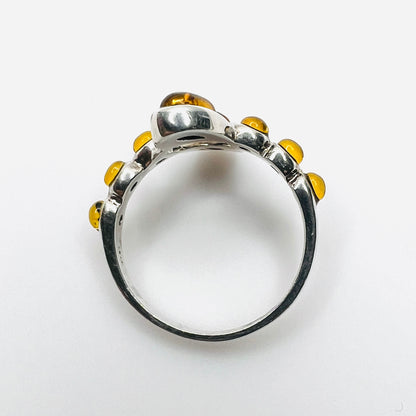 Top view of vintage S925 silver ring with cognac Baltic amber cabochons