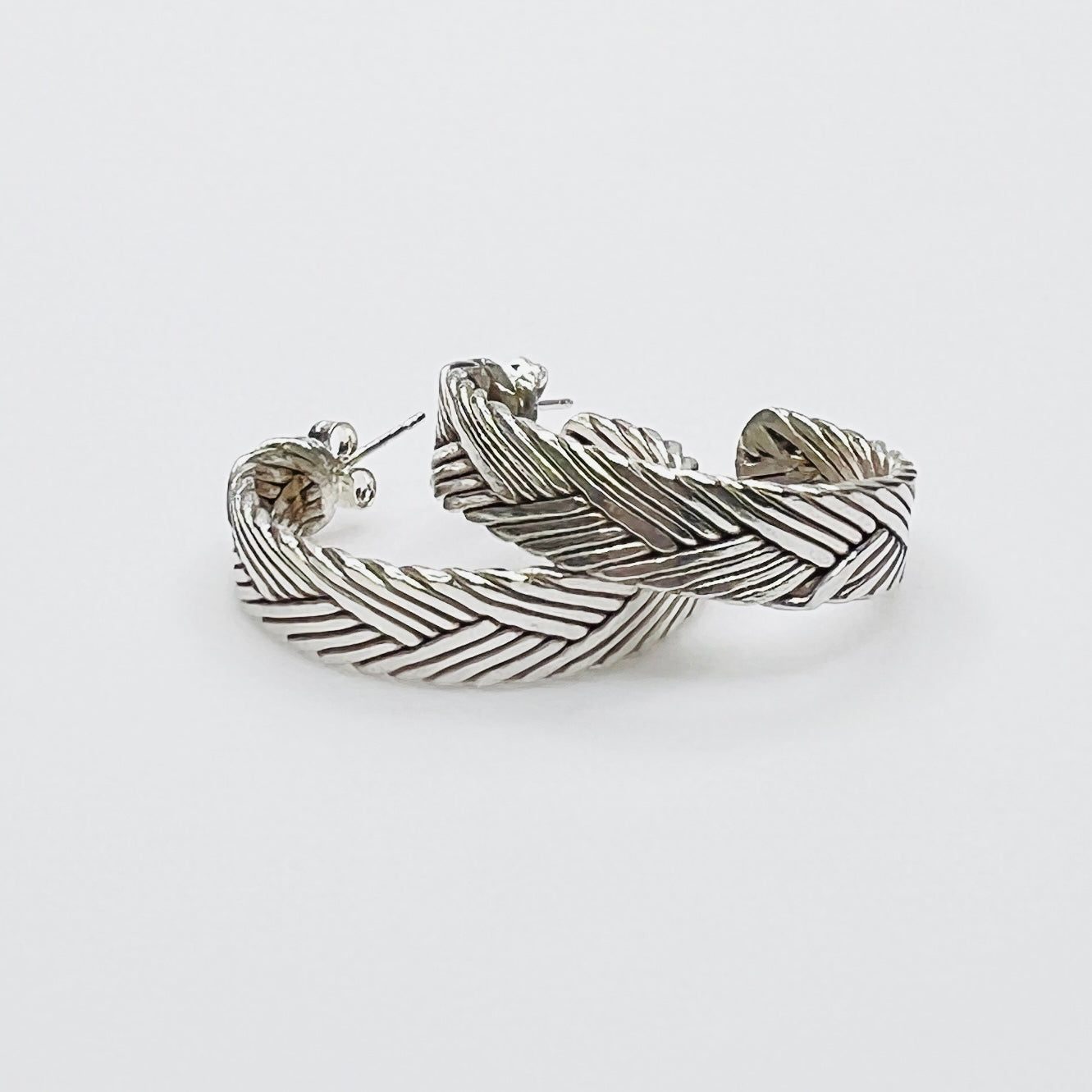 Vintage sterling silver twisted hoop earrings with textured design