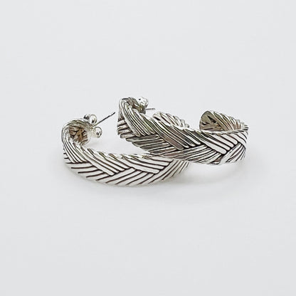 Vintage sterling silver twisted hoop earrings with textured design