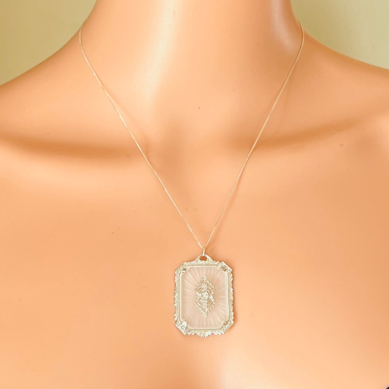 Vintage camphor glass pendant worn on neckline, Victorian style