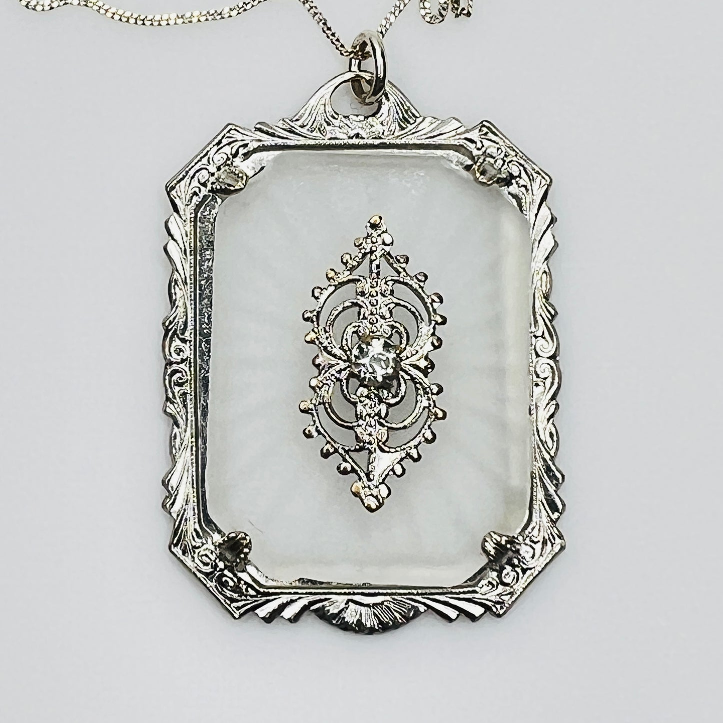 Close-up of ornate filigree detail with central rhinestone