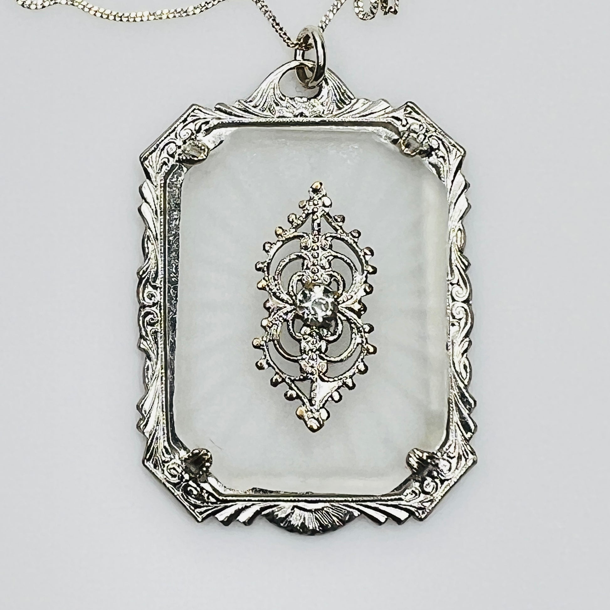 Close-up of ornate filigree detail with central rhinestone