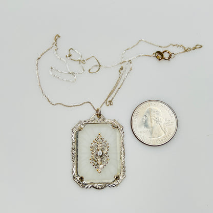 Pendant with quarter for size reference on silver chain