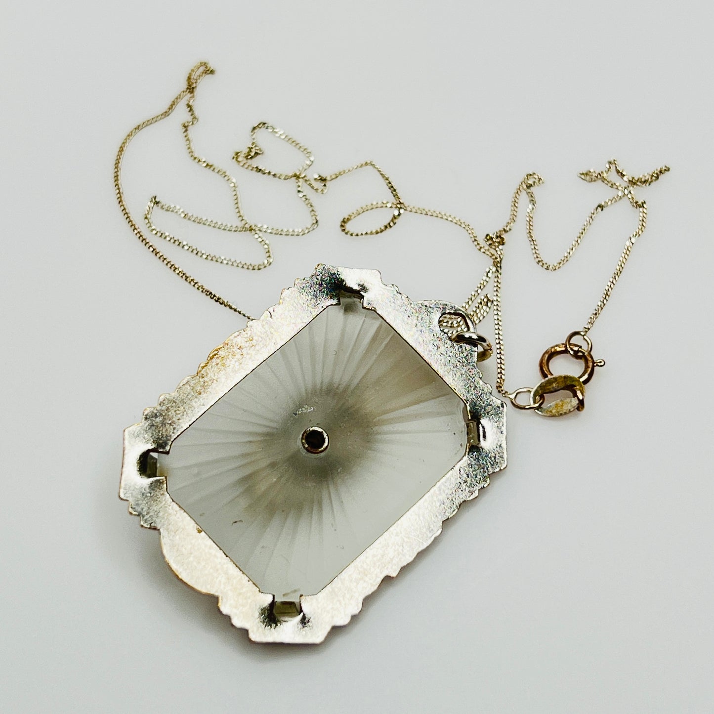 Back of camphor glass pendant with radiating etched pattern