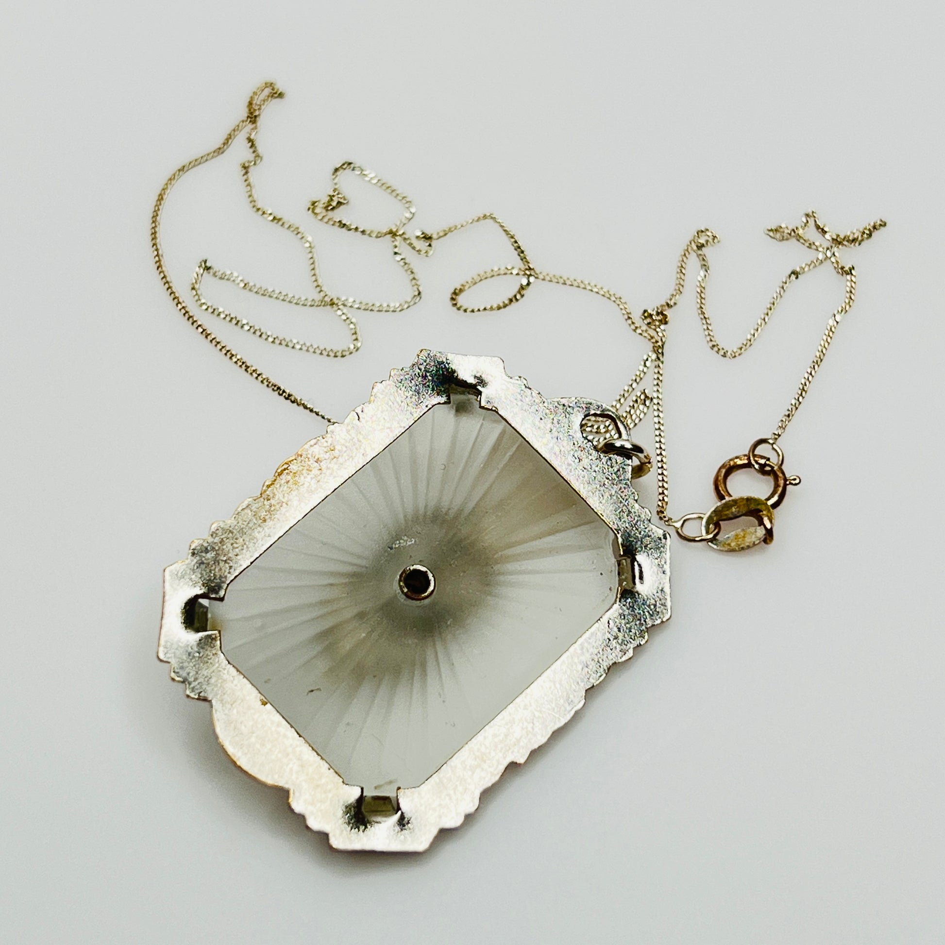 Back of camphor glass pendant with radiating etched pattern